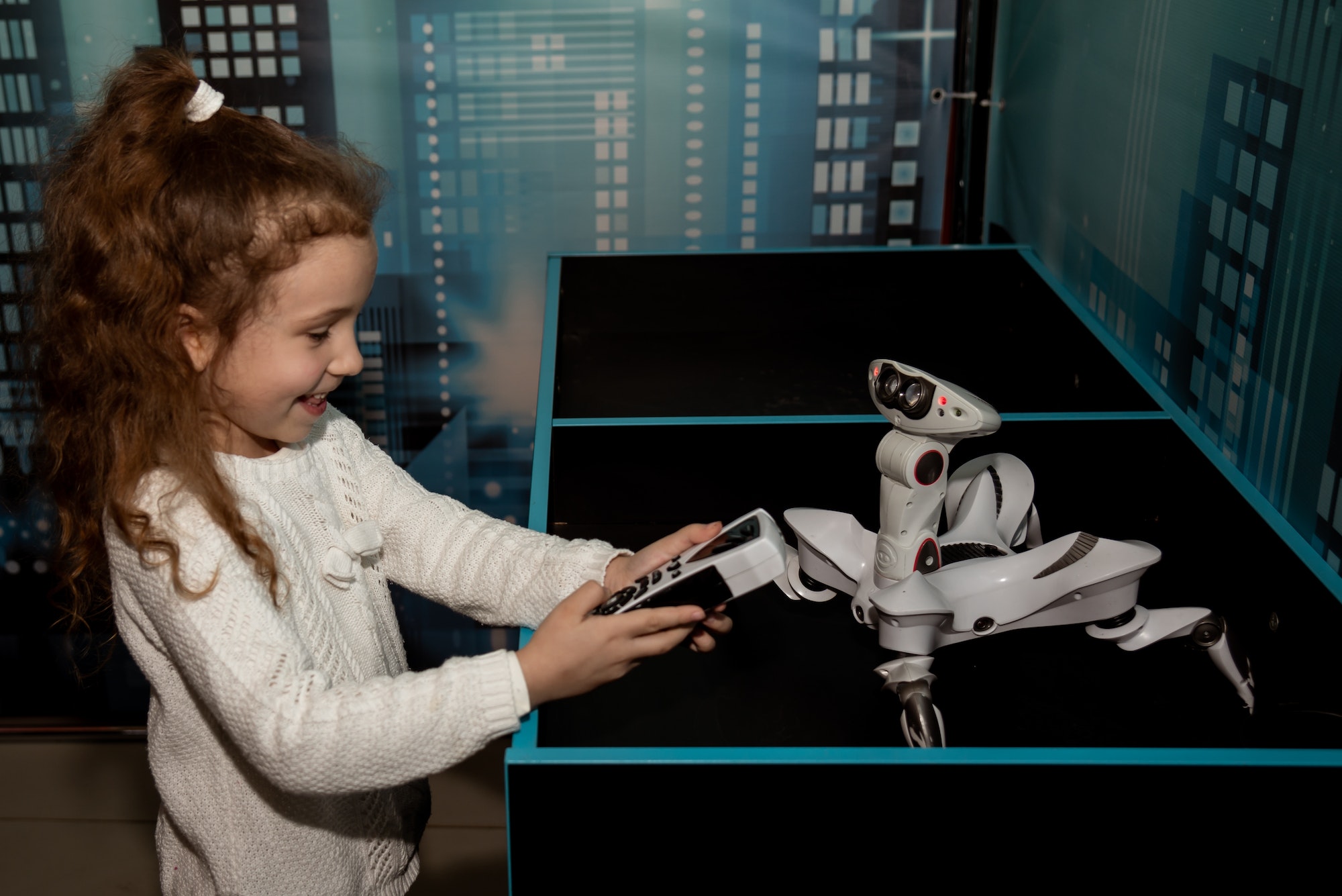 A girl at a robot show. Technology. Future.